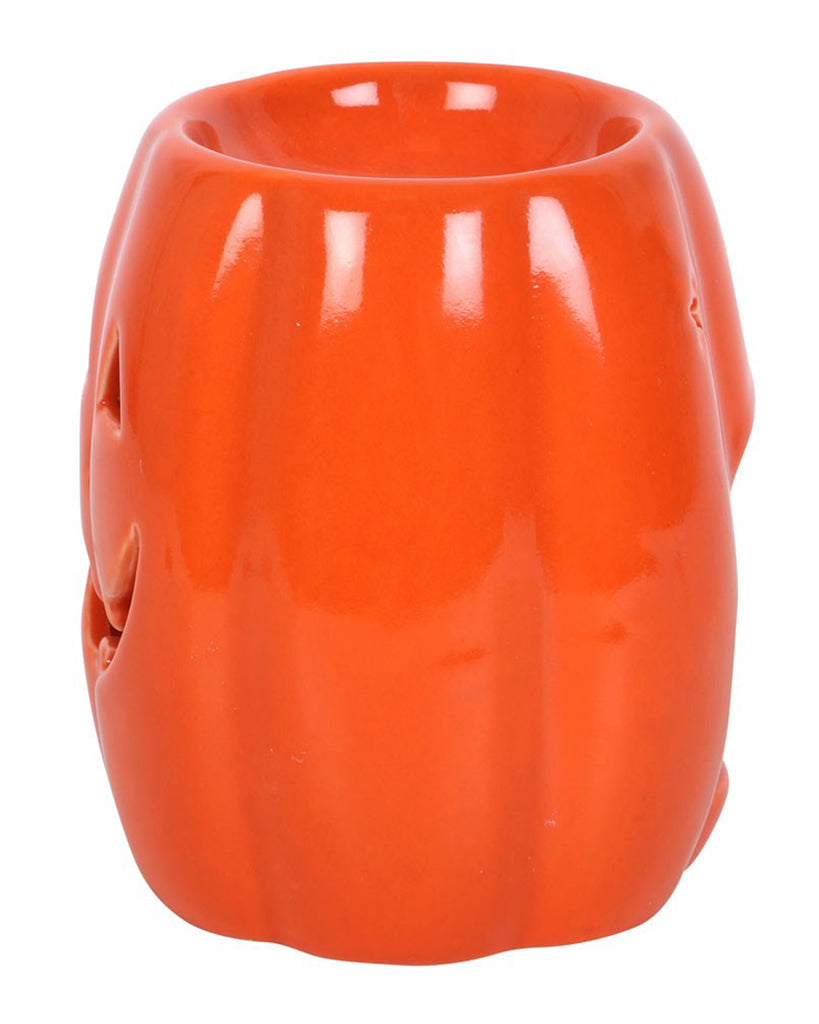 Angled side view of the Rebel Romance pumpkin wax warmer showing its star-shaped eye cut-outs and curved design. Adds a fun gothic touch to any spooky space.