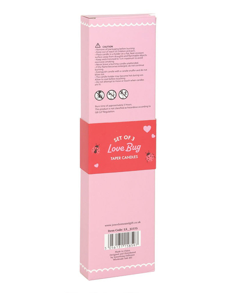 Close-up of the 3 Love Bug Ladybird Taper Candles, showing their white paraffin wax base adorned with vibrant red ladybirds in various poses. Ideal for adding a playful yet elegant touch to any room.