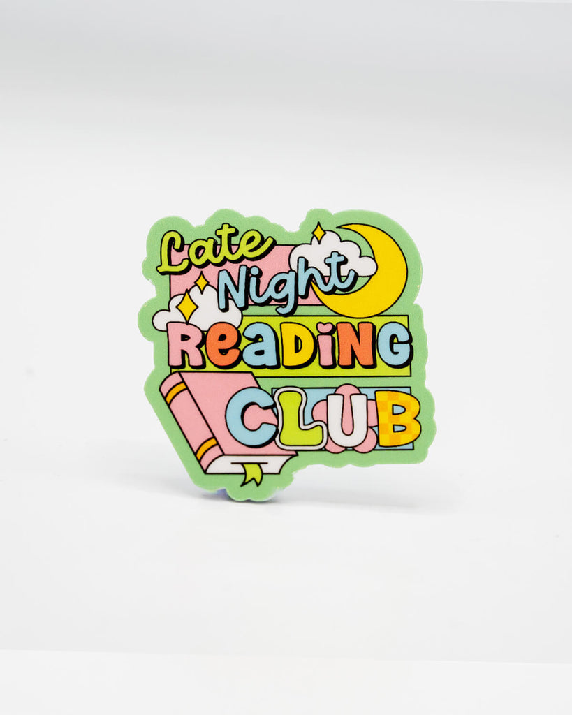 Colourful die-cut vinyl sticker featuring the words “Late Night Reading Club” in bold pastel letters with clouds, stars, a crescent moon, and a pink book. A playful, bookish design perfect for night owl readers and cosy aesthetic lovers. Created by Rebel Romance, a small UK business celebrating alternative style, slow fashion, and quirky millennial-friendly gifts.