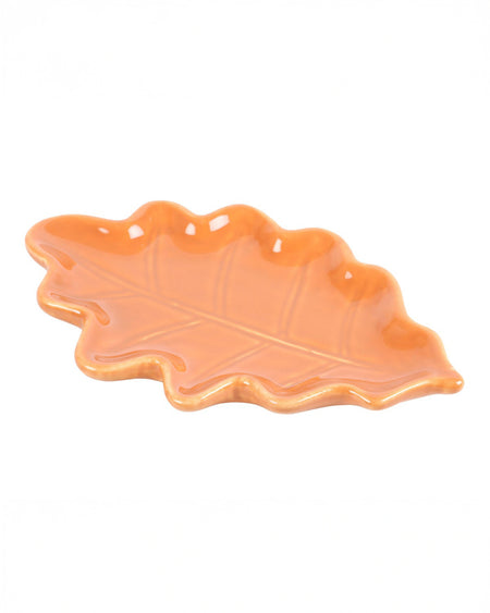 A side view of the Rebel Romance Autumn Leaf Dish, showcasing its raised edges and embossed leaf vein details. The ceramic dish has a natural shape and is ideal for storing small items or adding a cosy autumnal touch to any space.