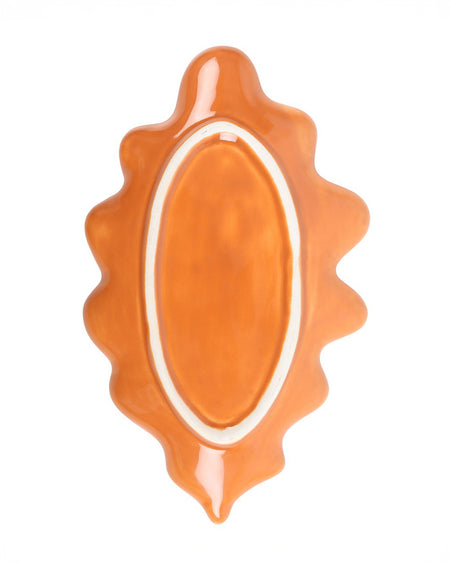 Back view of a ceramic autumn leaf-shaped dish in a rich, warm orange tone. The dish has a glossy finish with a delicate curved edge, resembling a fallen autumn leaf. Perfect for holding trinkets, jewellery, or as a decorative accent.