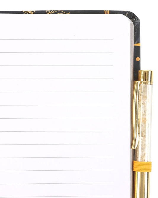 Notebook with a gold pen on a white background