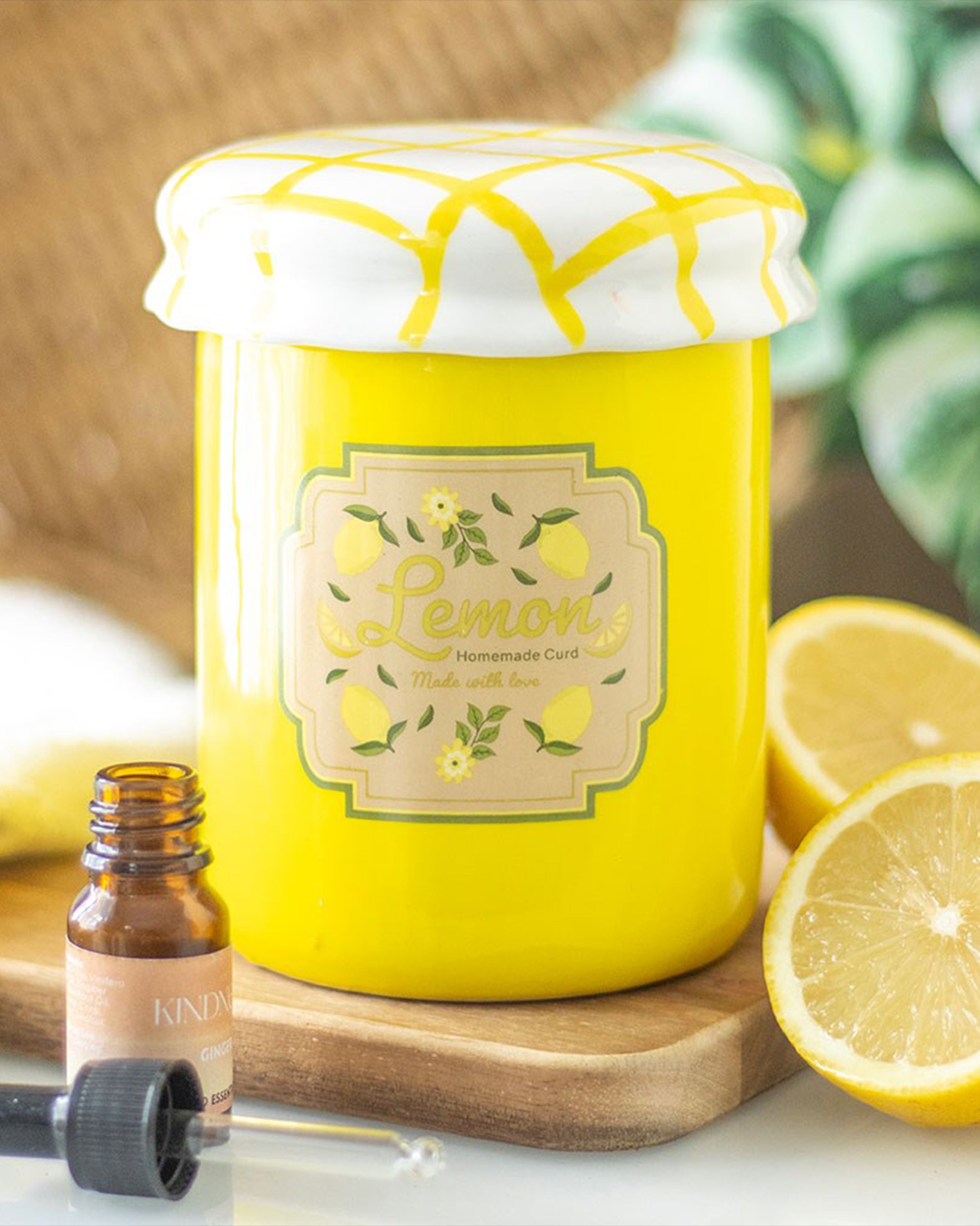 Styled shot of the Rebel Romance lemon curd jar oil burner and wax warmer, placed next to fresh lemons and essential oils. Its bright yellow colour and fun jam jar look make it an eye-catching, functional décor item for kitchens or living rooms.