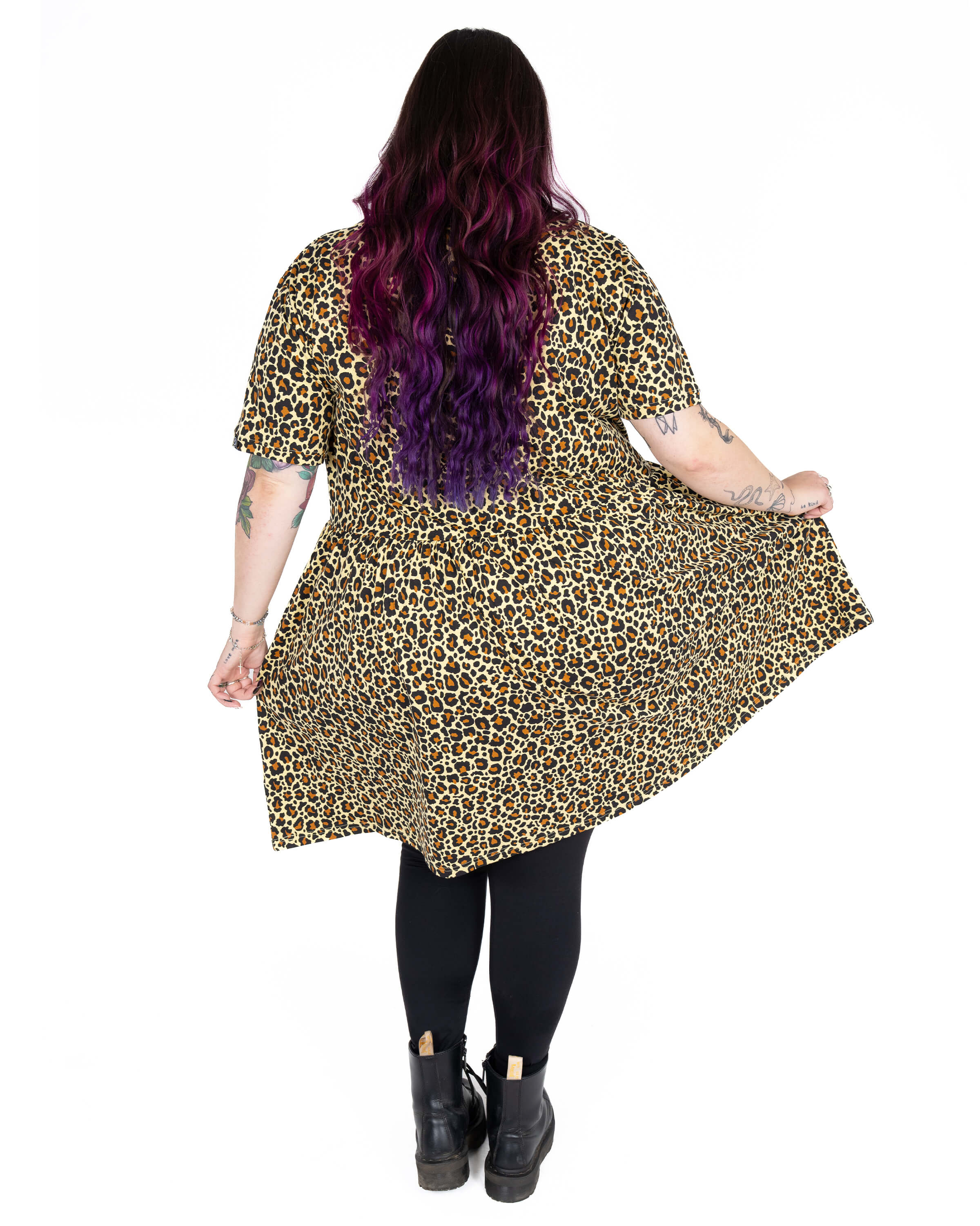 Back view of Luisa wearing the Rebel Romance Classic Leopard Print Stretch Smock Dress. The soft, stretchy fabric and oversized fit give the dress a flowy, flattering shape. Luisa (she/her) is 5'6