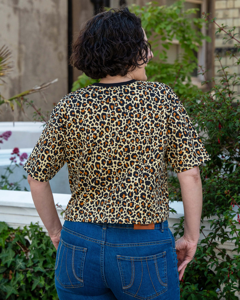Back view of Sarah wearing the Rebel Romance Classic Leopard Cropped Boxy Tee, showing the boxy cut and vibrant all-over leopard print. This ethical fashion tee is part of Rebel Romance’s alternative, bold clothing range.