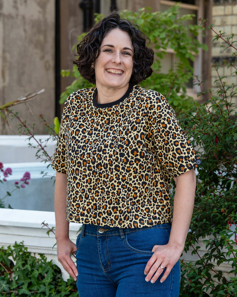 Side view of Sarah in the Rebel Romance Classic Leopard Cropped Boxy Tee, paired with jeans for a casual but fierce look. This cropped T-shirt is part of Rebel Romance’s inclusive slow fashion collection designed for self-expression.