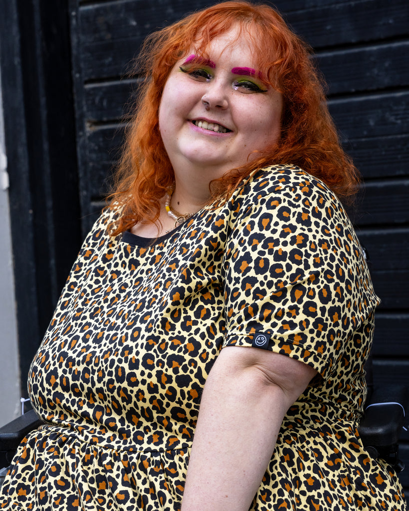 Close-up of Lauren smiling in the Rebel Romance leopard print stretch smock dress, showing the relaxed fit and soft cotton fabric.