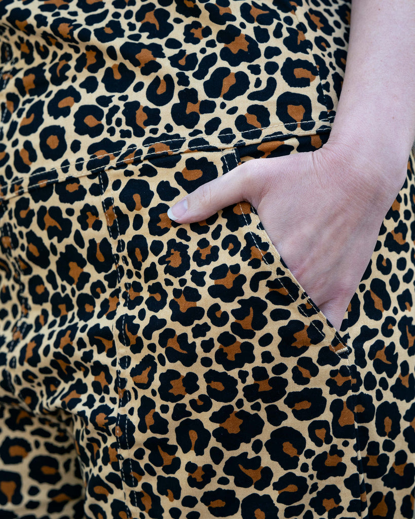 Detail shot of the front pocket and side seam of Rebel Romance Classic Leopard Print Stretch Dungarees, showing the durable stitching and eye-catching ethical design.