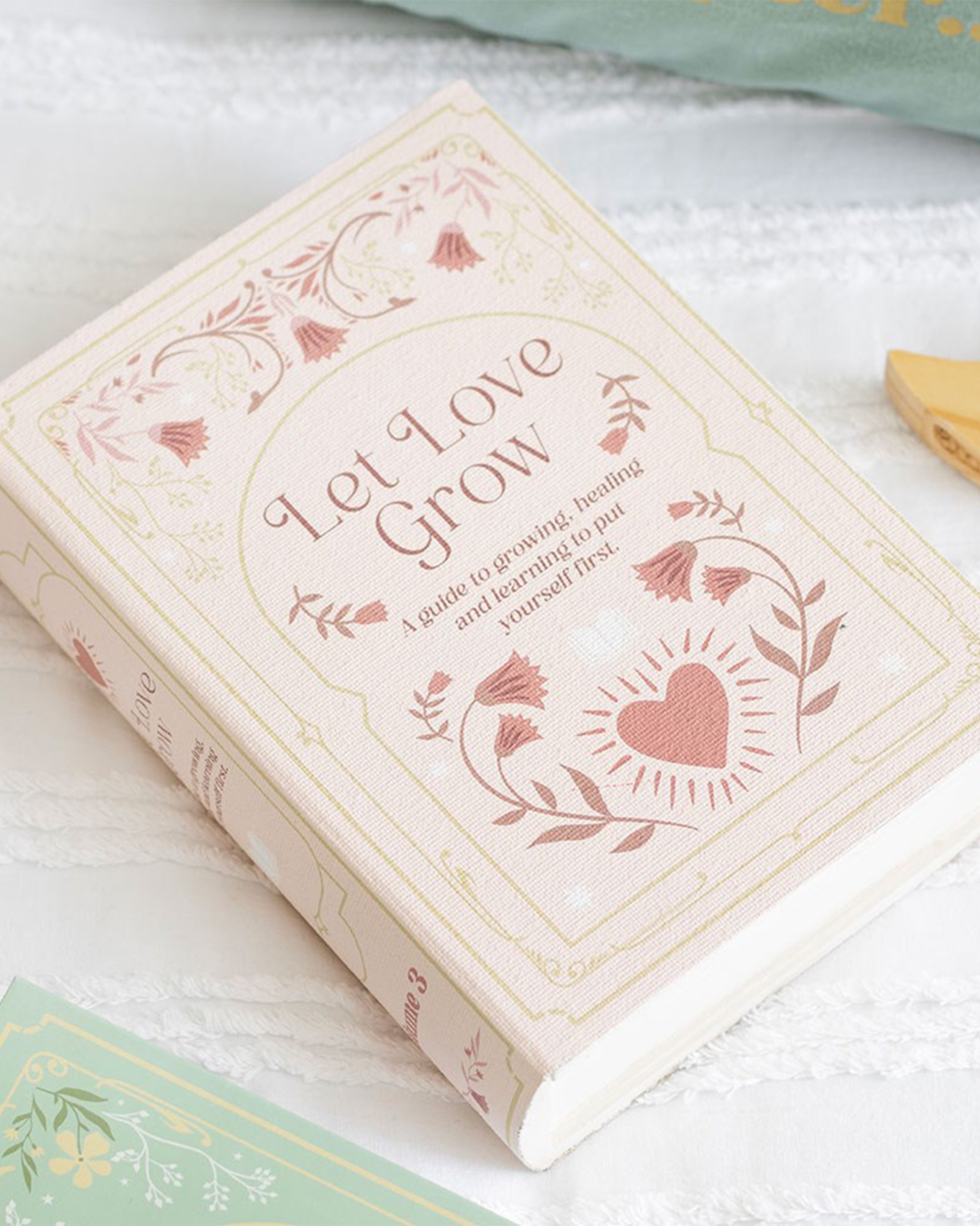 Rebel Romance Let Love Grow storage box styled like a pink vintage book with floral patterns. The perfect secret storage solution for stationery, jewellery, or keepsakes, adding charm and aesthetic to your home décor.
