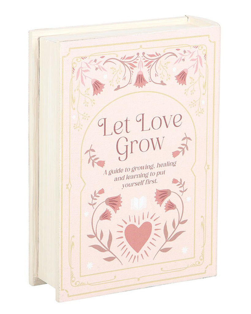 Let Love Grow book-shaped storage box by Rebel Romance, styled as a vintage pink hardback with floral details and an uplifting quote. A charming decorative storage solution that doubles as home décor while hiding small treasures or stationery.