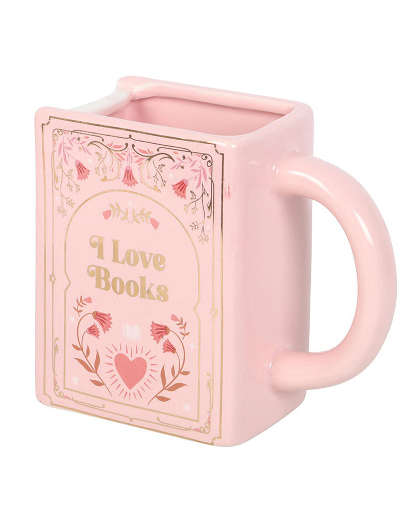 Close-up of the Rebel Romance “I Love Books” pink ceramic mug shaped like a book. Features gold lettering, floral detailing, and a heart design, making it the perfect gift for readers and bookworms.