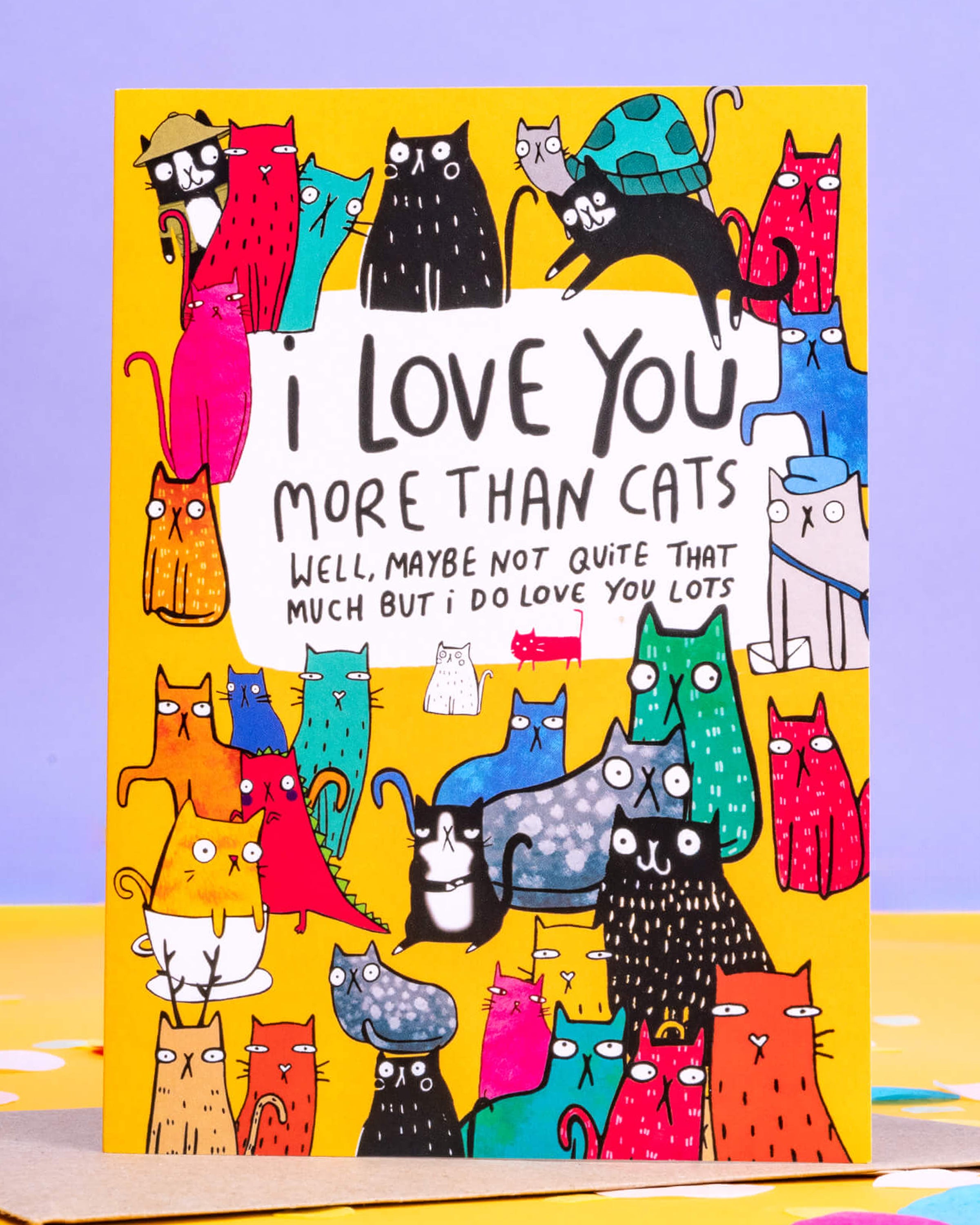 A colourful A6 greeting card from Rebel Romance featuring quirky illustrated cats in vibrant colours surrounding the text 