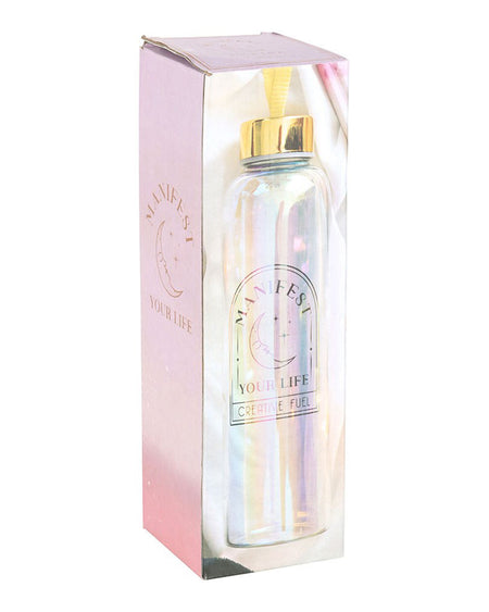 Manifest Your Life iridescent glass water bottle in its original pastel pink and gold packaging. The box features moon and star designs, aligning with Rebel Romance's whimsical, mystical aesthetic.
