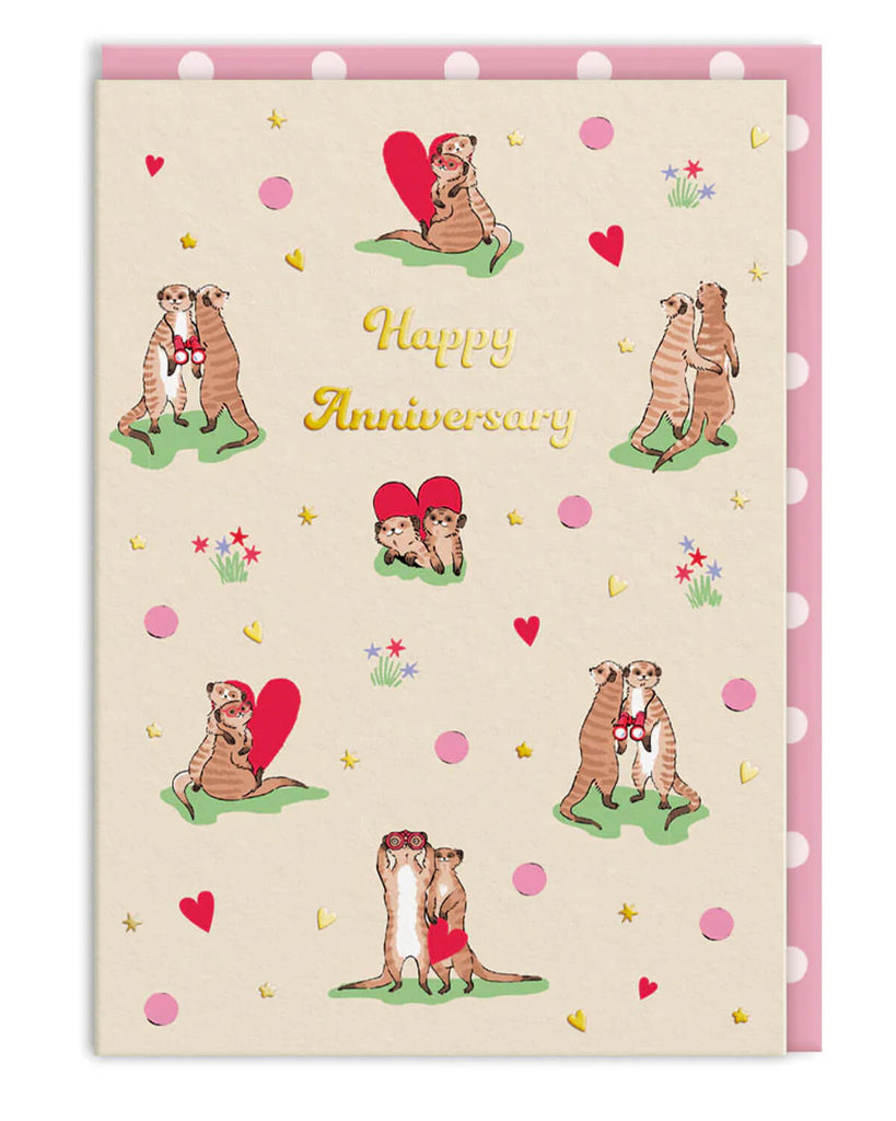 A6 anniversary card featuring cute illustrated meerkats holding hearts, cuddling, and sharing sweet moments, surrounded by colourful hearts and flowers. Designed by Cath Kidston and stocked by Rebel Romance, this card includes silver foil accents and a pink spotty envelope. A perfect card for anniversaries, love celebrations, and animal lovers who appreciate charming, whimsical stationery.