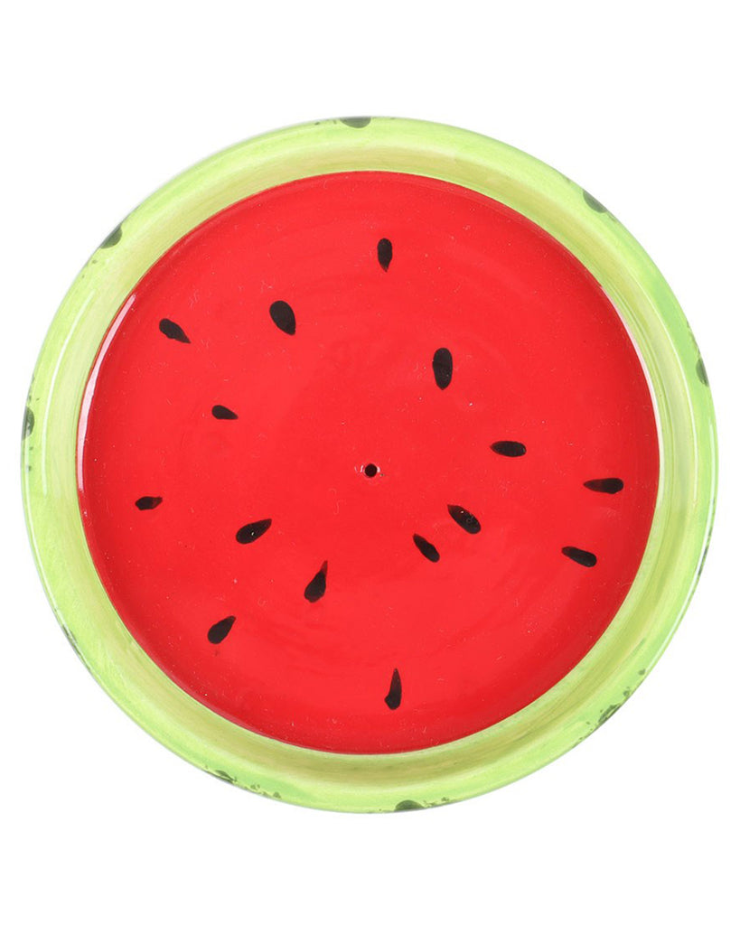 A top-down view of the watermelon-shaped incense stick holder, featuring a bright red surface with black seeds and a vibrant green rim. Ideal for adding a playful touch to any space.