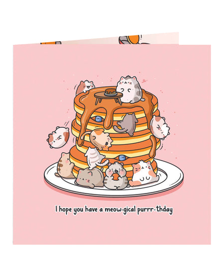 Close-up of a square pink birthday card with cute illustrated cats on a pancake stack and the pun “I hope you have a meow-gical purrr-thday.” Ideal for cat lovers. Designed by Toastedink and stocked by Rebel Romance, a UK brand for quirky, nostalgic gifts.