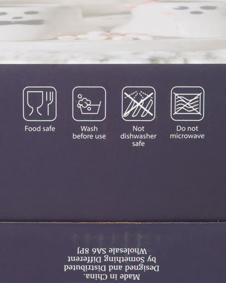 Close-up of the packaging for the Mr and Mrs Boo ghost mug set from Rebel Romance. The box features care instructions, stating that the mugs are food-safe, should be washed before use, and are not dishwasher or microwave safe. The dark background contrasts with the white text and icons.