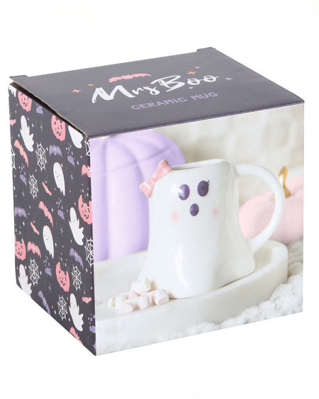 The Mrs Boo ghost-shaped ceramic mug shown inside its box packaging. The mug features a pink bow and a sweet face, surrounded by pastel Halloween-themed illustrations.