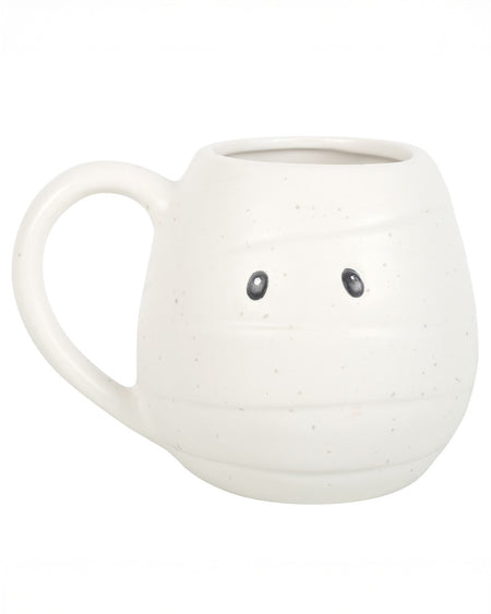 Front-facing image of the mummy mug showing black cartoon eyes and wraparound bandage texture. A perfect spooky season essential.