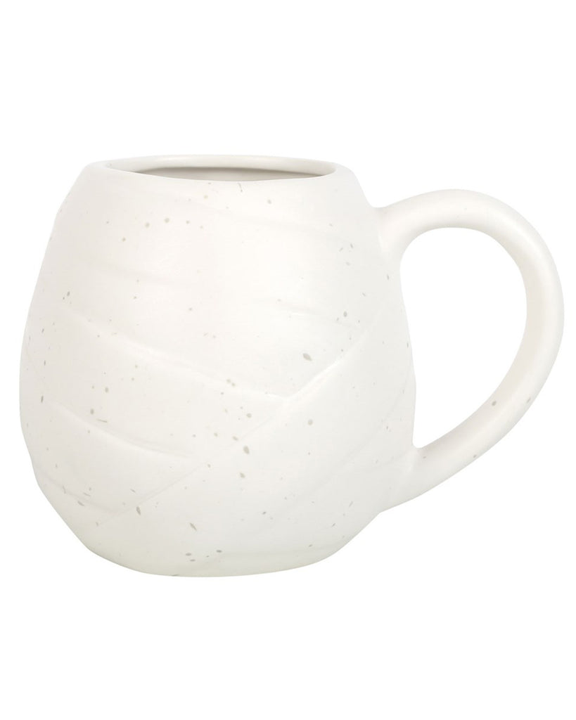 Rear view of the mummy mug showing the curved handle and subtle speckled finish across the white ceramic.