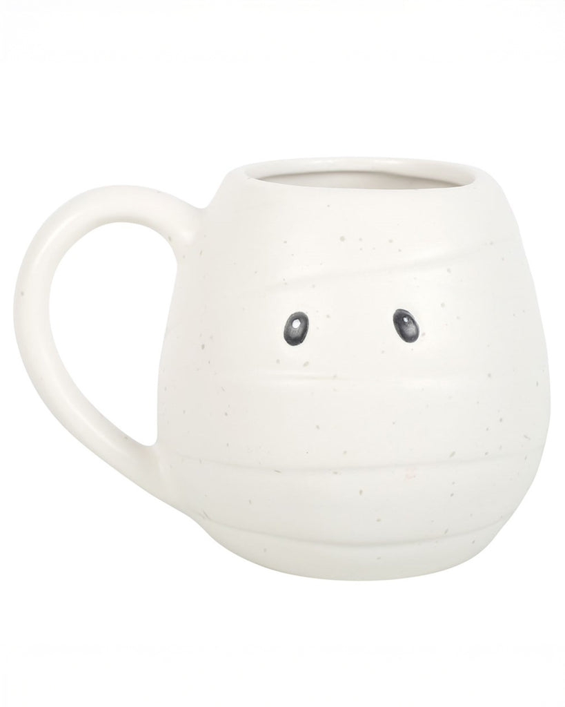 Front-facing image of the mummy mug showing black cartoon eyes and wraparound bandage texture. A perfect spooky season essential.