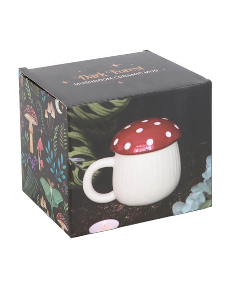  The mushroom mug in its forest-themed gift box, featuring dark and mystical botanical illustrations of mushrooms, moths, and leaves for a witchy, enchanted look.