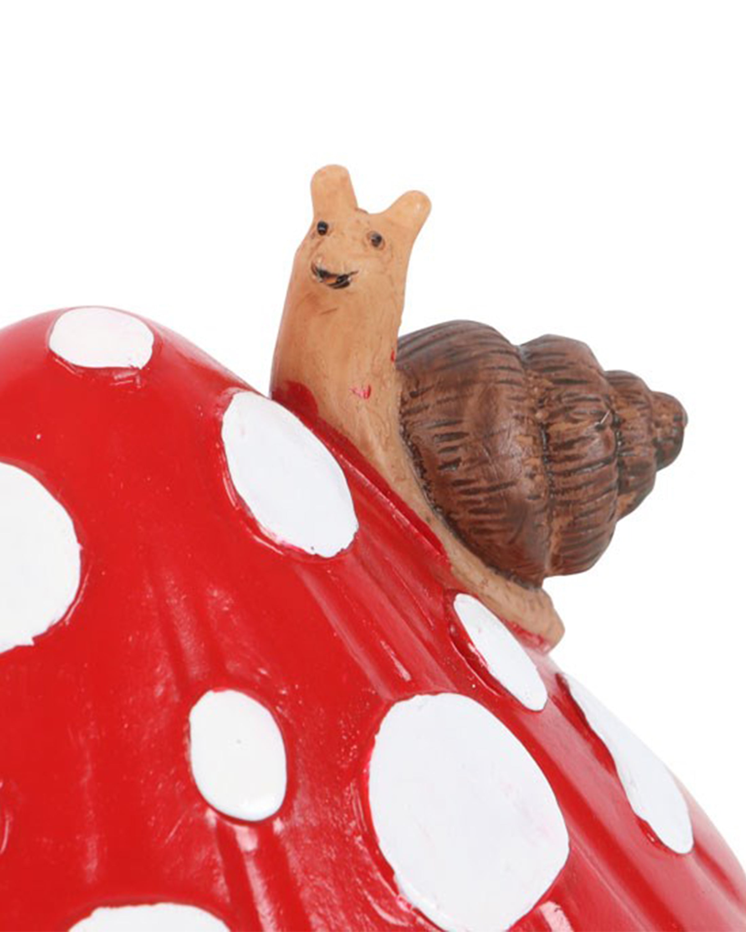Close-up of the smiling snail figure sitting atop the mushroom house incense burner. The snail has a brown shell and sits on a glossy red-and-white toadstool roof. From Rebel Romance’s alternative homeware range.
