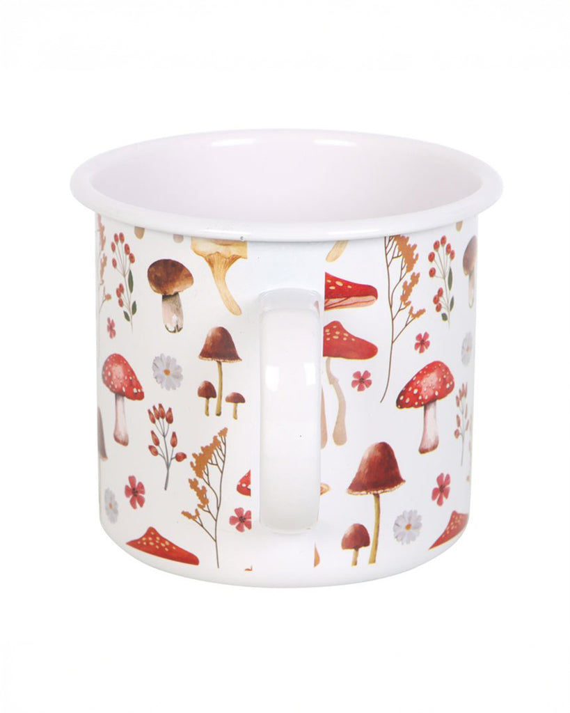 A side view of the all-over mushroom print enamel mug, featuring a variety of toadstools, wildflowers, and ferns. The classic white enamel with a curved handle makes it an ideal camping or everyday mug.