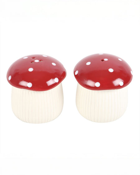 Front view of Rebel Romance’s Mushroom Salt & Pepper Shaker Set, showing the distinct hole patterns on each red mushroom cap to differentiate between salt and pepper. Cottagecore style gift for a new home.