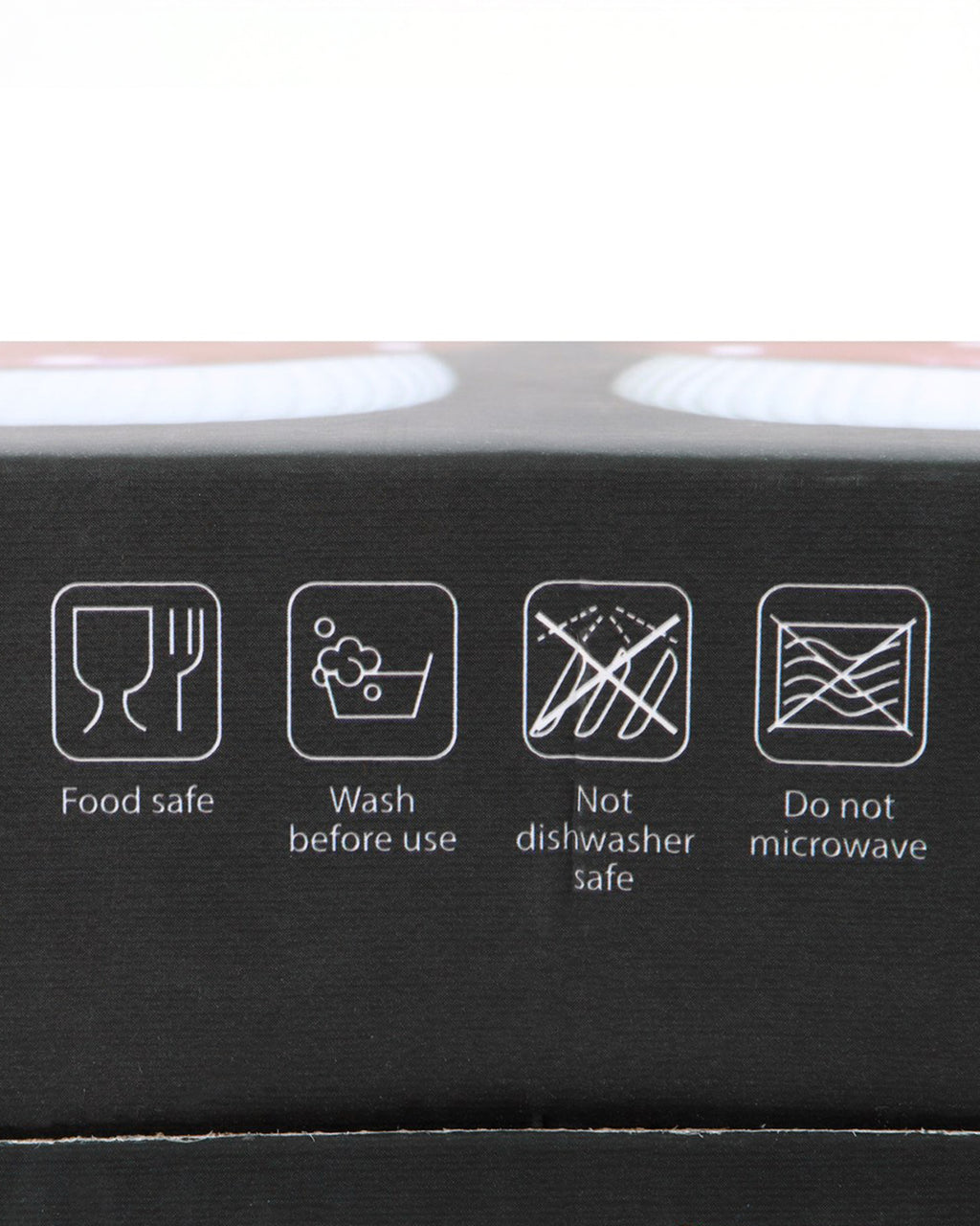 Close-up of icons on the packaging of the Mushroom Salt & Pepper Shaker Set by Rebel Romance, showing care instructions: food safe, wash before use, not dishwasher safe, and do not microwave.