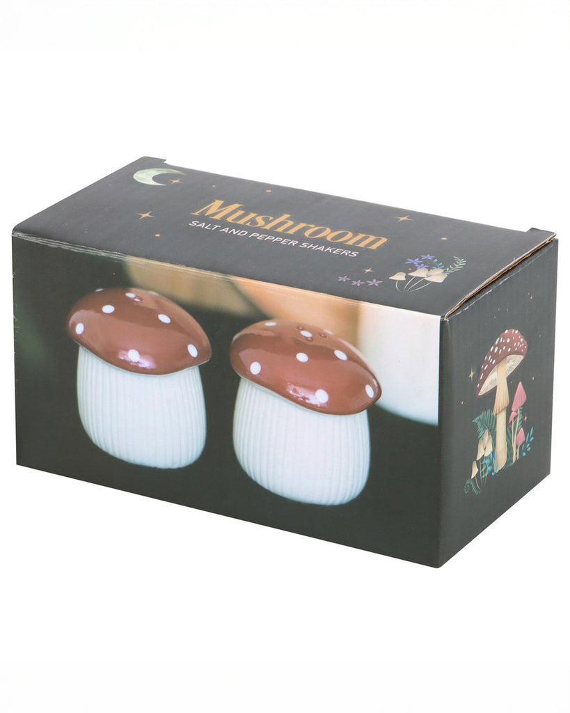 Box packaging for the Rebel Romance Mushroom Salt & Pepper Shaker Set, featuring two ceramic mushroom shakers with red and white spotted caps. The whimsical box design includes illustrations of mushrooms and stars.