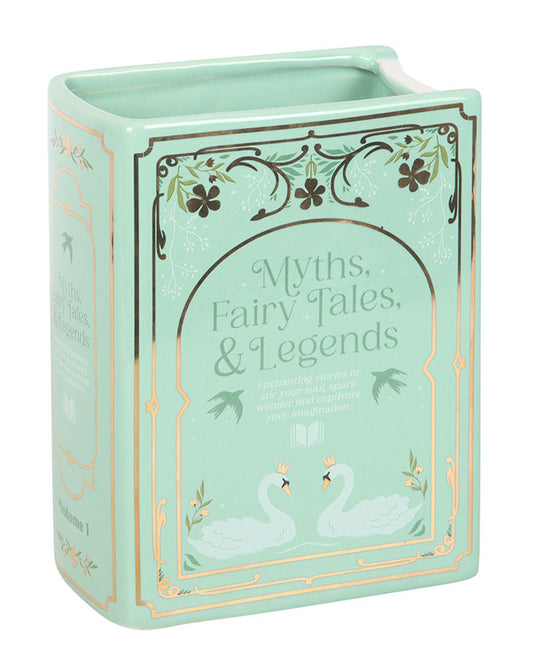 Angled view of the Rebel Romance Myths, Fairy Tales & Legends Green Book Shaped Vase. The ceramic design features a mint green book with ornate detailing, crowned swans, and floral illustrations, ideal for fantasy fans and book-inspired home décor.