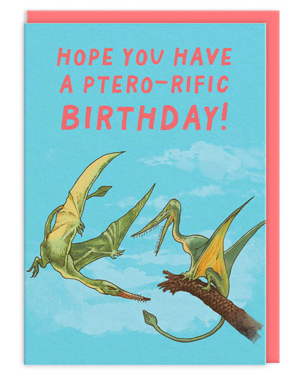 A6 dinosaur birthday card with three illustrated pterodactyls flying in a bright blue sky and the text “Hope You Have a Ptero-rific Birthday!” in red, finished with a neon coral envelope. Designed by the Natural History Museum.