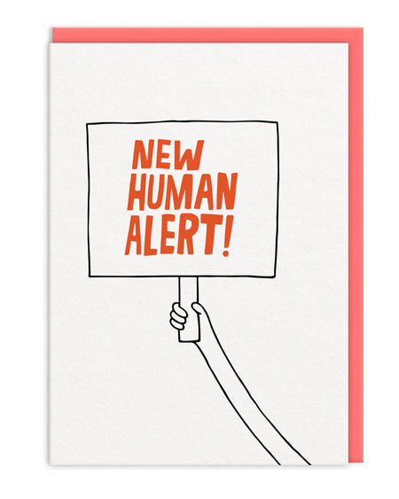 A6 greeting card from Rebel Romance featuring a playful hand-drawn placard with bold orange text that reads “NEW HUMAN ALERT!” in block capitals. The sign is held by a simple cartoon arm against a white background. Includes a bright coral envelope tucked inside. A fun and quirky way to celebrate a new baby arrival. Ideal for millennials who love alternative, retro-inspired designs from an independent UK brand.
