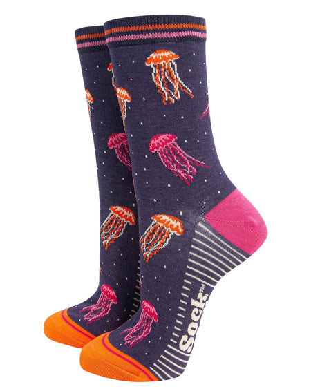 (Socks Standing Up): A pair of bamboo jellyfish socks displayed upright, highlighting the floating jellyfish design, striped cuff, and bold pink and orange accents on the heel and toe.
