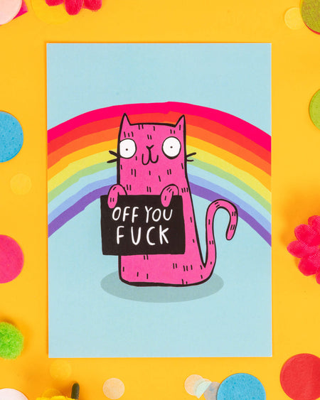 A colourful A6 postcard featuring a pink cartoon cat holding a sign that says “Off You F*ck” with a rainbow in the background. Designed by Katie Abey, this cheeky, sweary card is perfect for millennials who love bold humour, alternative stationery, and sending a playful “go away” message with charm.
