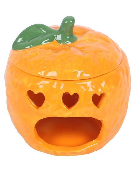 A close-up of the orange oil burner, showing heart-shaped cutouts that allow light to shine through when a tealight is placed inside. The vibrant orange colour and lifelike details make it a standout decor piece, perfect for adding warmth to any room.