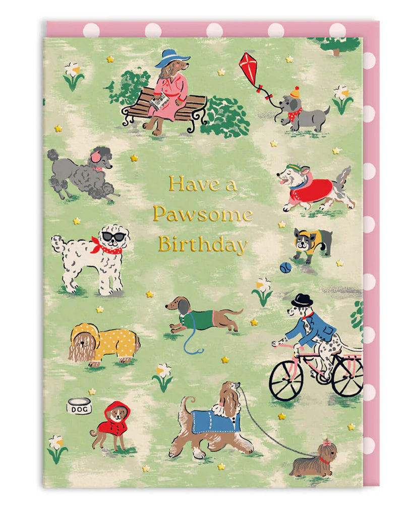 Cath Kidston A6 birthday card featuring illustrated dogs in a park setting with people, gold foil text reading “Have a Pawsome Birthday”, and a pink spotty envelope. Ideal birthday card for dog lovers and retro stationery fans.
