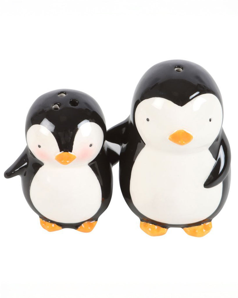 Close-up of the hugging penguins ceramic shaker set, showing orange feet, white tummies, and rosy cheeks for a cheerful festive look.