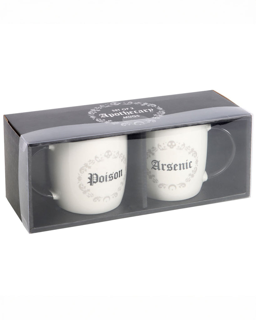 A black boxed witchy gift set of Poison and Arsenic Mugs from Rebel Romance. The two white mugs with black handles are displayed in a gothic-style black gift box with decorative skulls and filigree details.