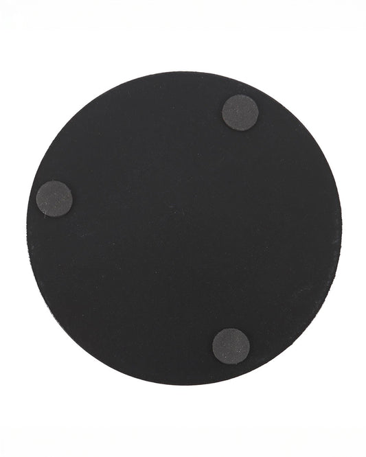 Black round coaster base with three small padded feet on the bottom for grip. This image shows the reverse side of one of the Poisonous Plants coasters by Rebel Romance, a small UK brand celebrating alternative aesthetics and unique homeware.