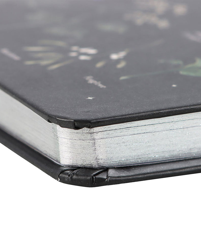 Detail of the silver-edged pages and durable hardcover binding of the Rebel Romance Poisonous Plants A5 Notebook, adding a touch of elegance to this gothic-inspired stationery piece.