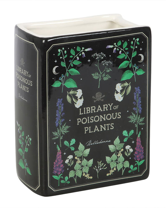 Angled close-up of the Rebel Romance ceramic Poisonous Plants Vase styled as a vintage black book with colourful plant illustrations and the word "Belladonna" on the cover. Ideal for holding flowers or as a spooky shelf display piece.