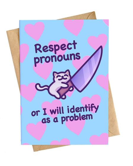 Product photo of the “Respect Pronouns or I Will Identify as a Problem” card by Mona Mauve for Rebel Romance. Blue background with pink hearts and a cheeky cartoon cat holding a knife. Includes kraft brown envelope, ideal for gender identity and trans rights support.