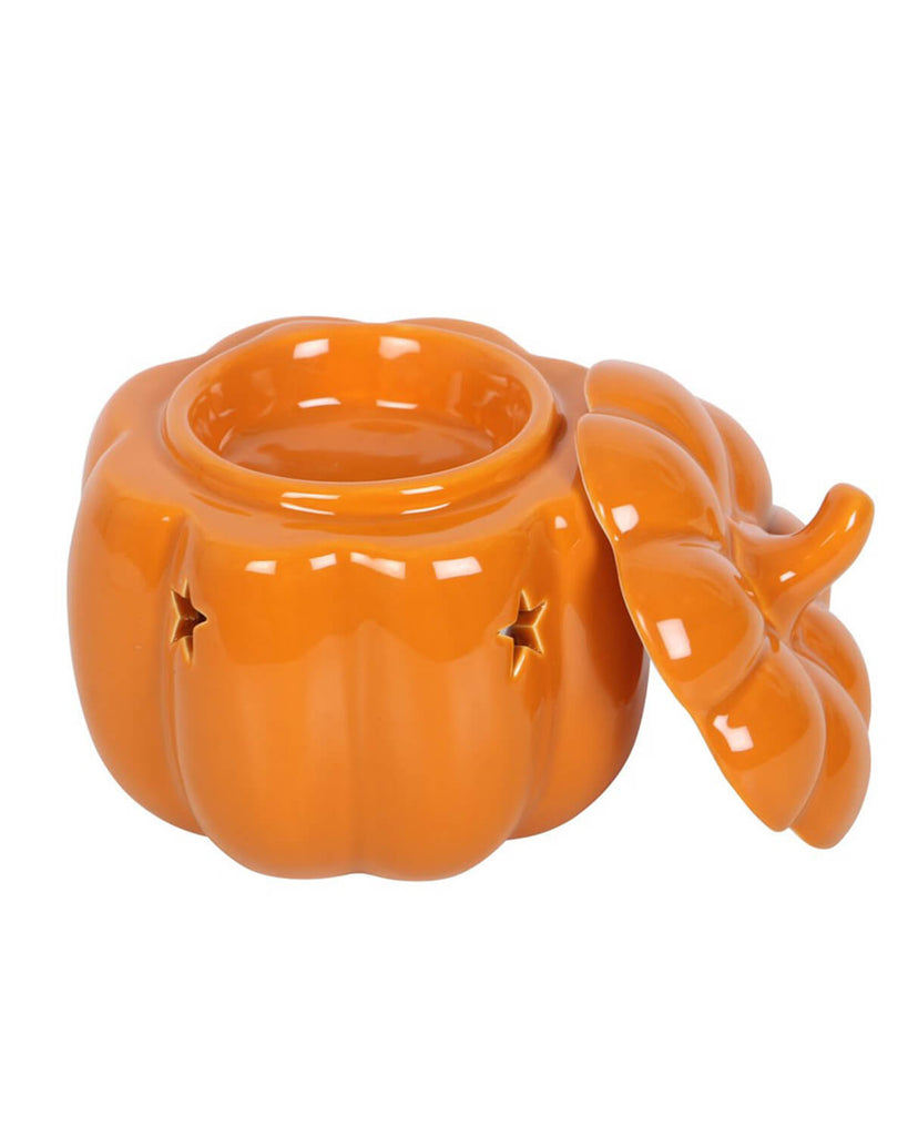 Top view of the pumpkin burner with its lid removed, highlighting the oil dish and glossy ceramic finish.