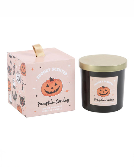 The full Pumpkin Carving candle and its packaging side by side, featuring a spiced pumpkin scent and charming Halloween design, perfect for autumn vibes.