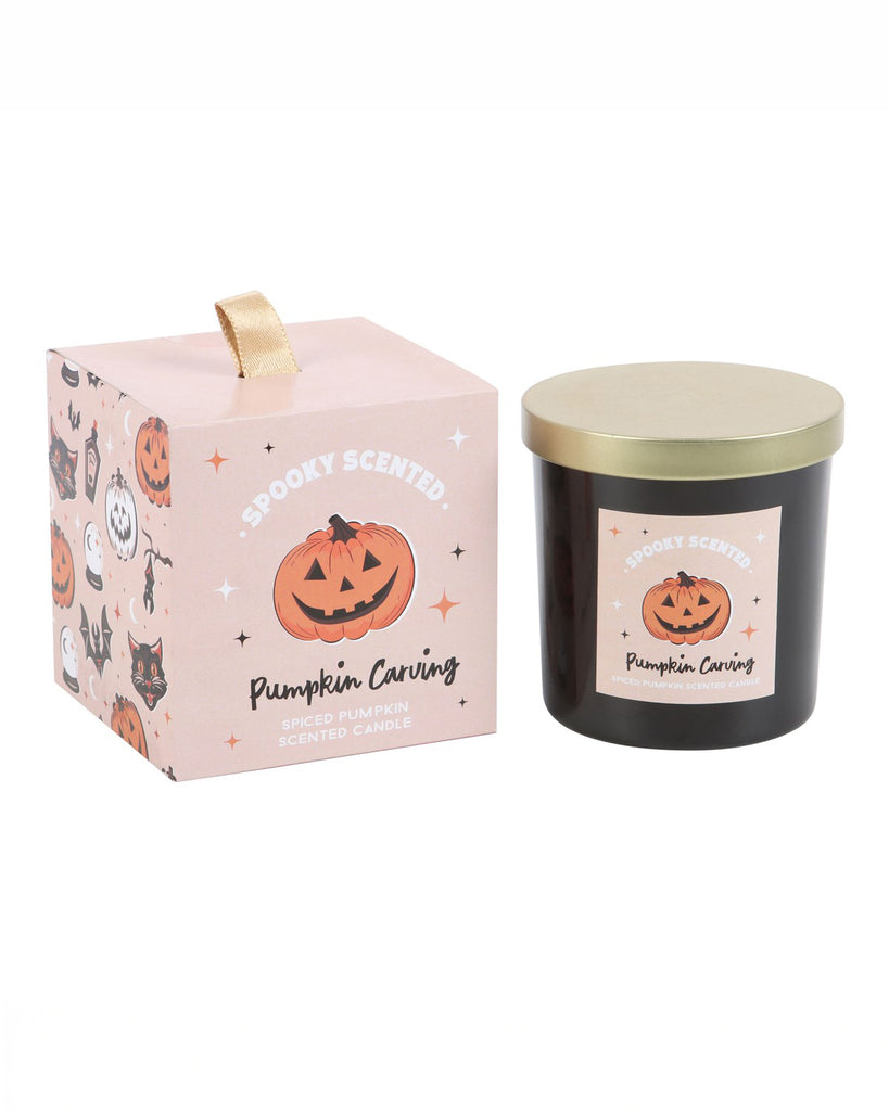 The full Pumpkin Carving candle and its packaging side by side, featuring a spiced pumpkin scent and charming Halloween design, perfect for autumn vibes.