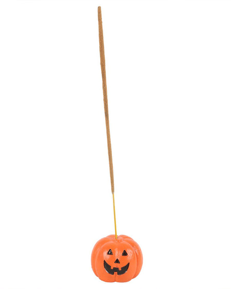 Orange jack-o'-lantern incense stick holder from Rebel Romance shown in use with a lit incense stick. A quirky and practical piece of gothic Halloween home décor.