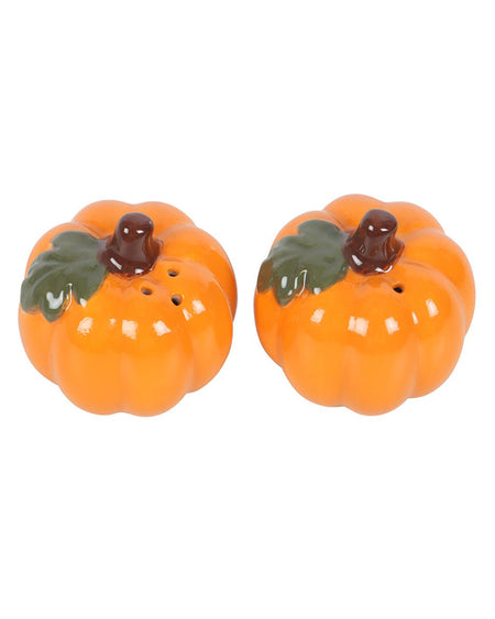 Top view of two ceramic pumpkin salt and pepper shakers from Rebel Romance, showing shaker holes. Each pumpkin has a dark brown stalk and green leaf detailing, perfect for spicing up your spooky season table setting.