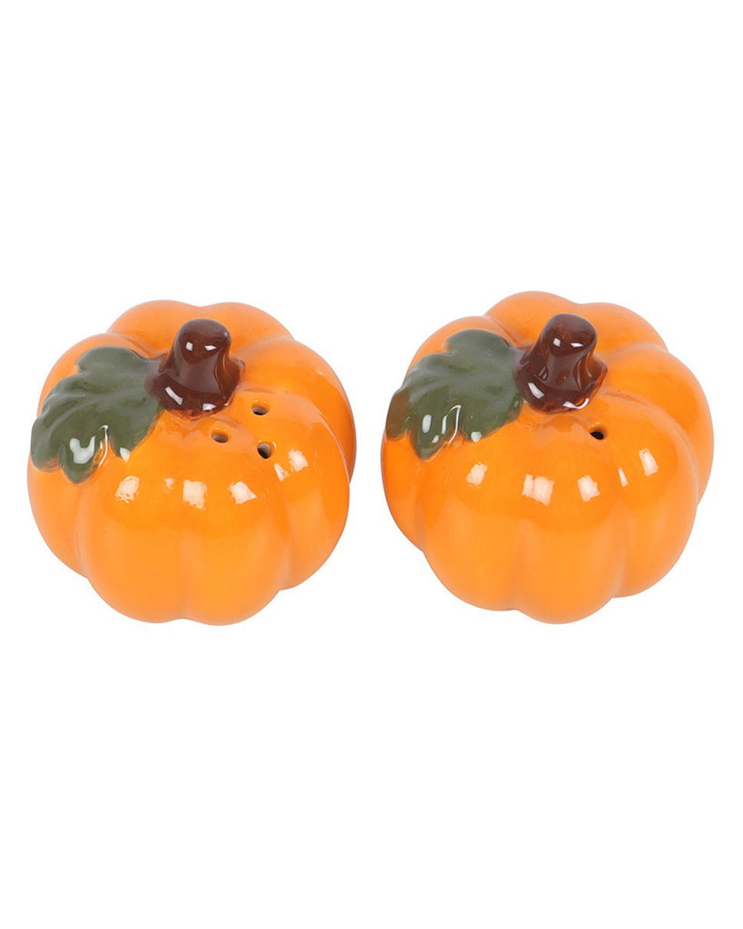 Top view of two ceramic pumpkin salt and pepper shakers from Rebel Romance, showing shaker holes. Each pumpkin has a dark brown stalk and green leaf detailing, perfect for spicing up your spooky season table setting.